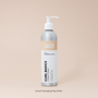 Bottle of Curl Basics Conditioner on a beige background