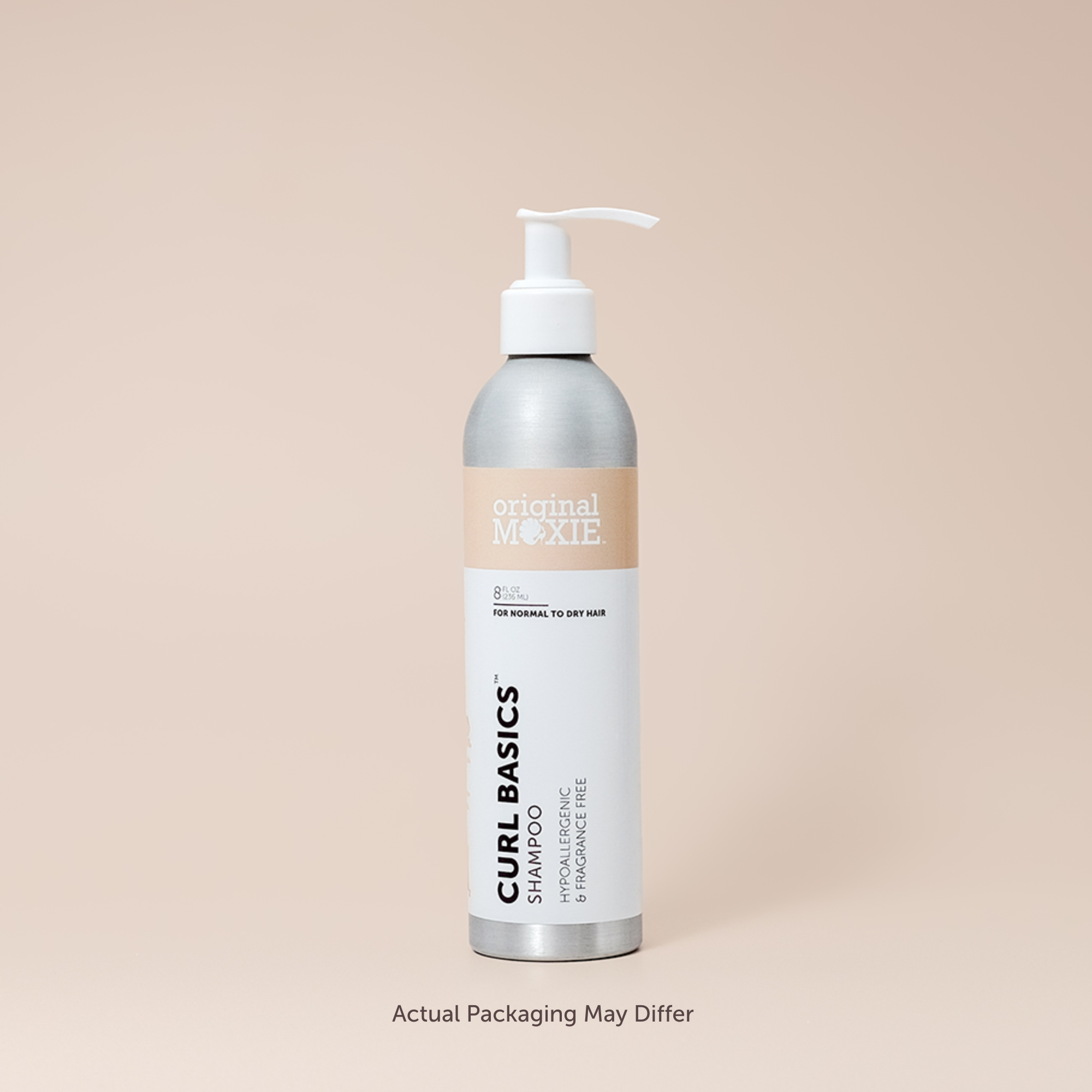 Bottle of Curl Basics Shampoo with pump on a beige background